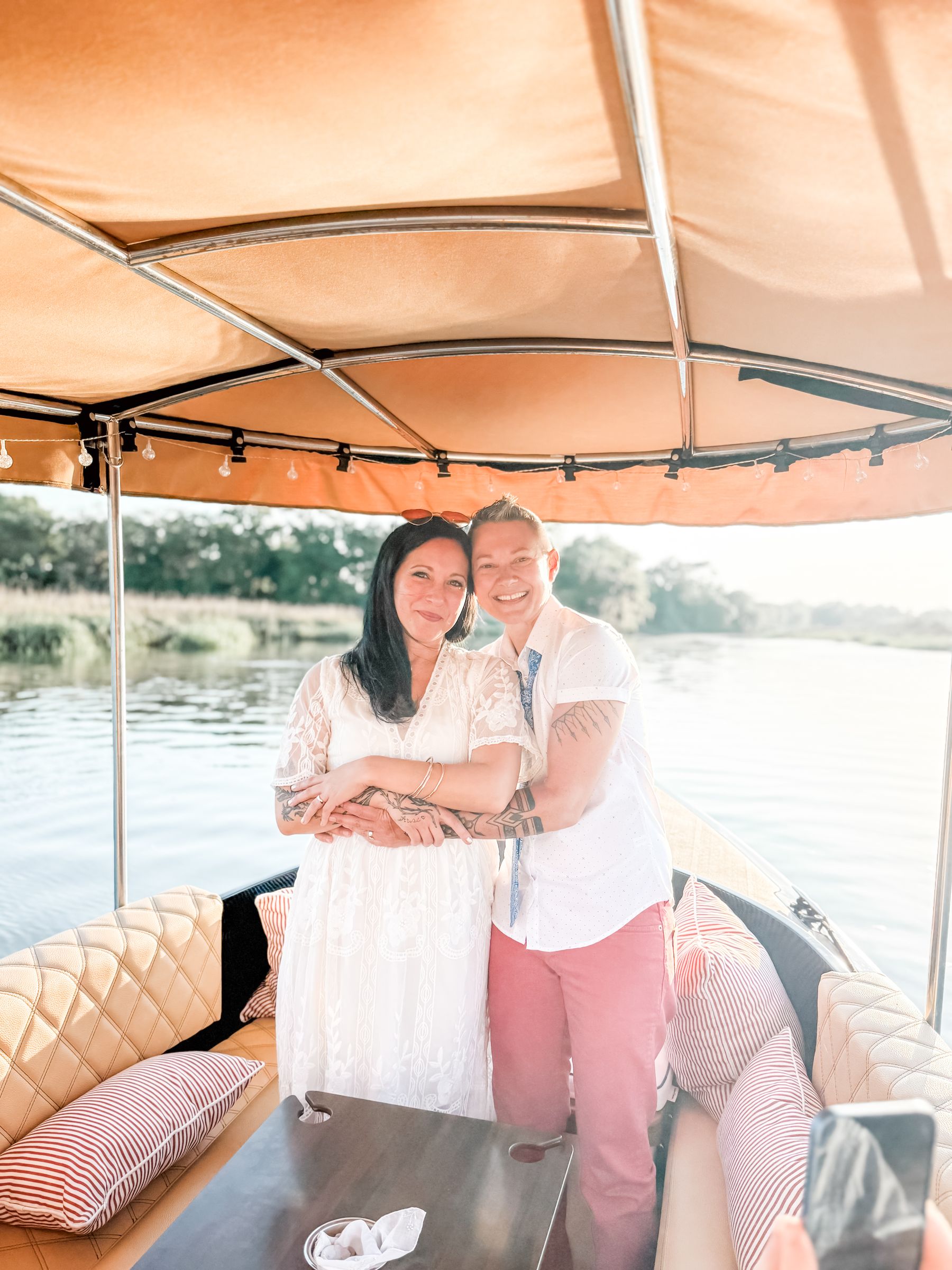 A newly married couple embracing under the Joyride canopy after their on-board elopement