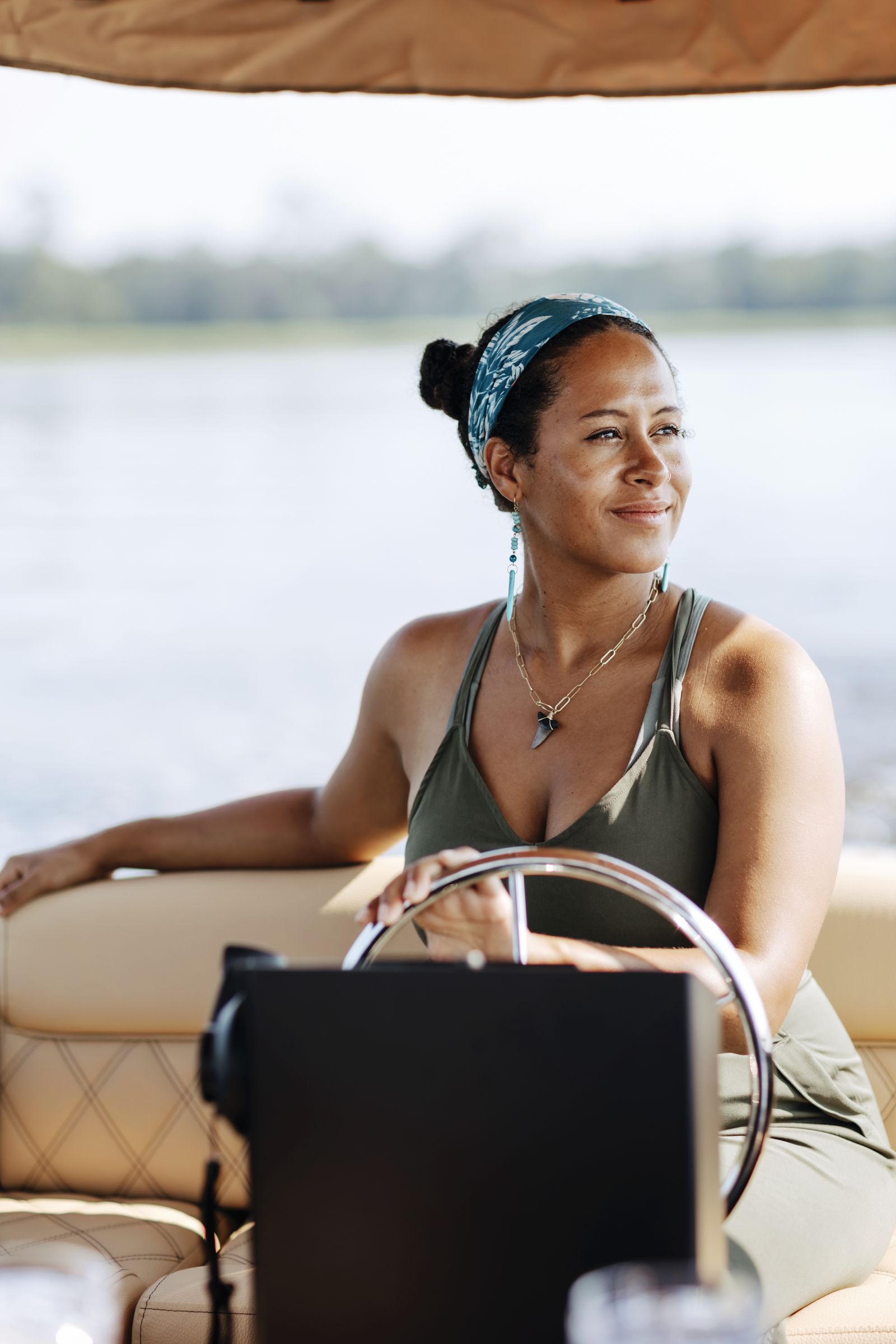Captain Taryn smiling at the helm of the Joyride boat