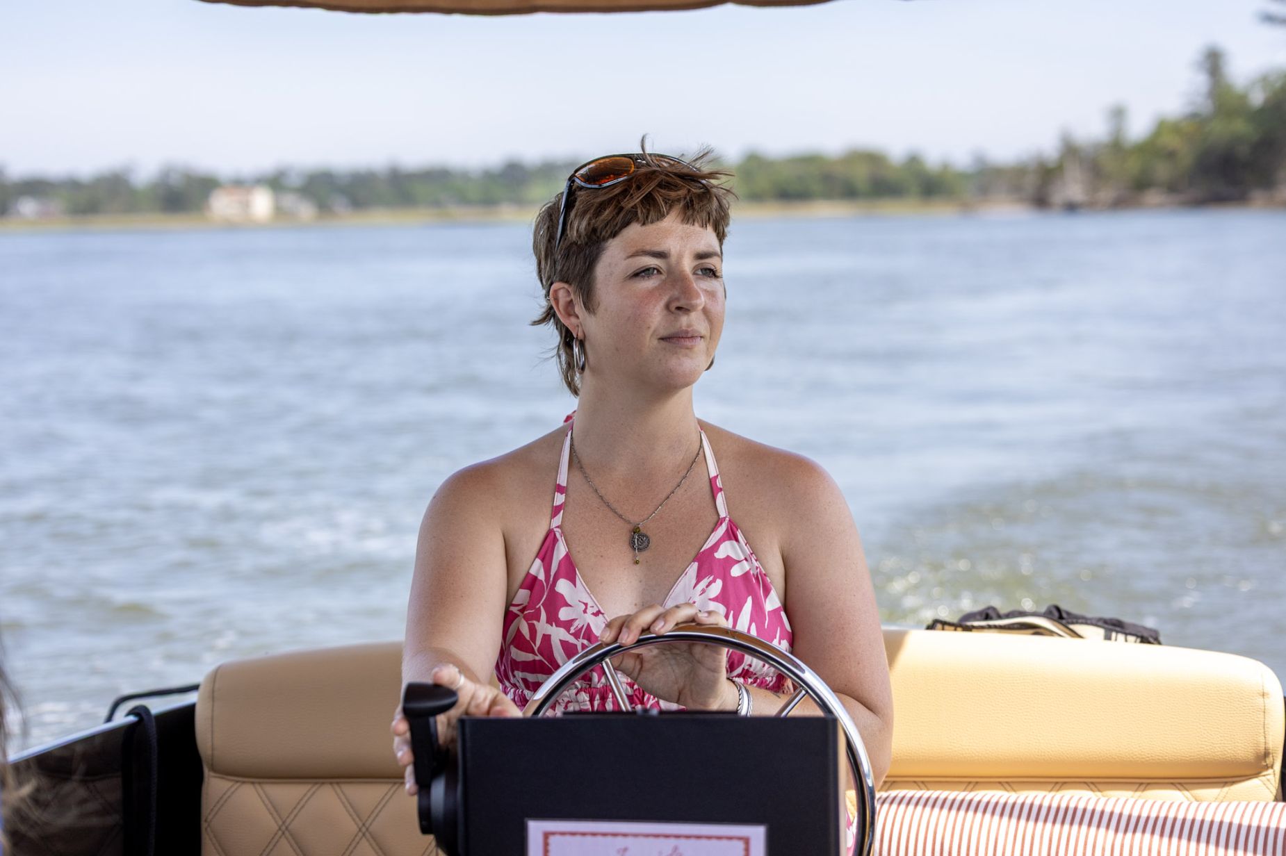 Captain Ellie at the helm, the river behind her