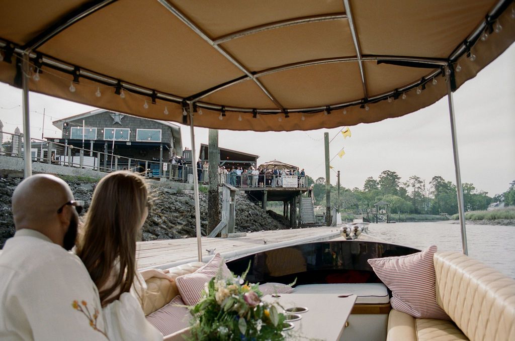 Approaching The Wyld's dock by Joyride, guests gathered on the restaurant's waterfront deck