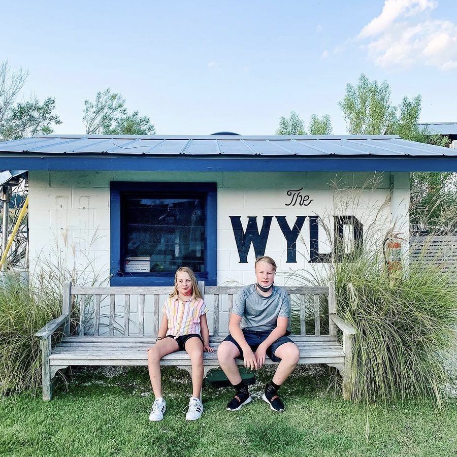 Audra's two kids on a bench at The Wyld, 2020