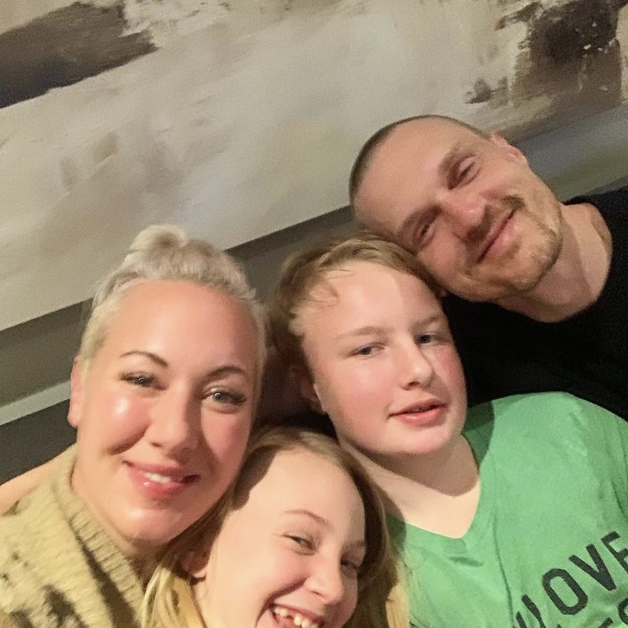 Audra, Justin and their two kids in a family selfie